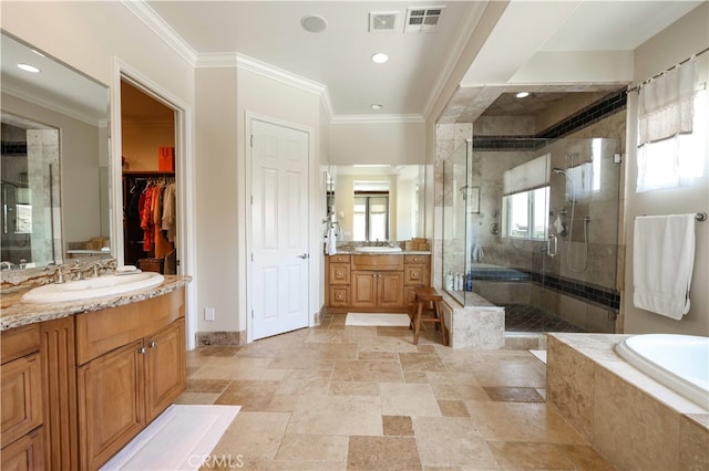 bathroom featuring ornamental molding, plenty of natural light, vanity, and separate shower and tub