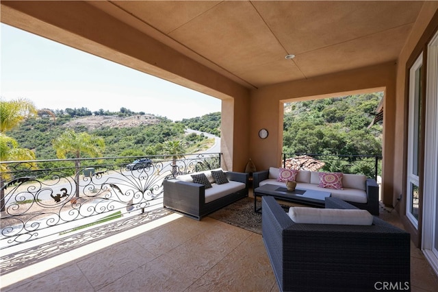 view of patio with an outdoor hangout area and a balcony