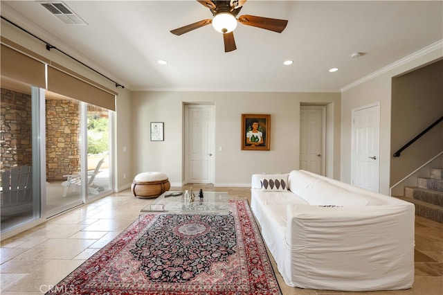 living room with ornamental molding and ceiling fan