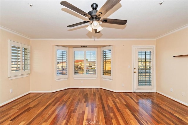 empty room with ceiling fan, hardwood / wood-style floors, and ornamental molding