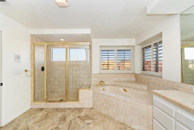 bathroom with vanity and separate shower and tub