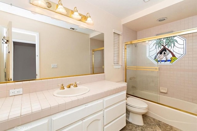 full bathroom with toilet, combined bath / shower with glass door, and vanity