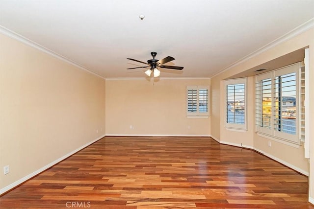 empty room featuring wood-type flooring and crown molding