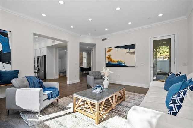 living room featuring dark wood-type flooring and ornamental molding