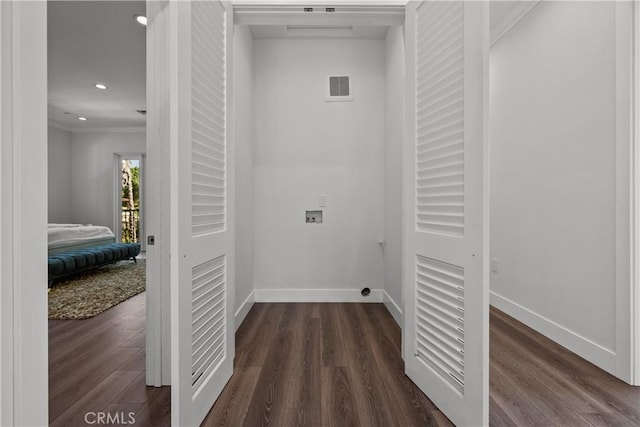 washroom featuring washer hookup, dark hardwood / wood-style flooring, and ornamental molding