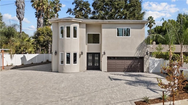 view of front of home with a garage and french doors