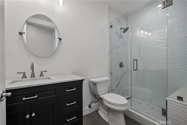 bathroom featuring tile patterned floors, vanity, toilet, and an enclosed shower