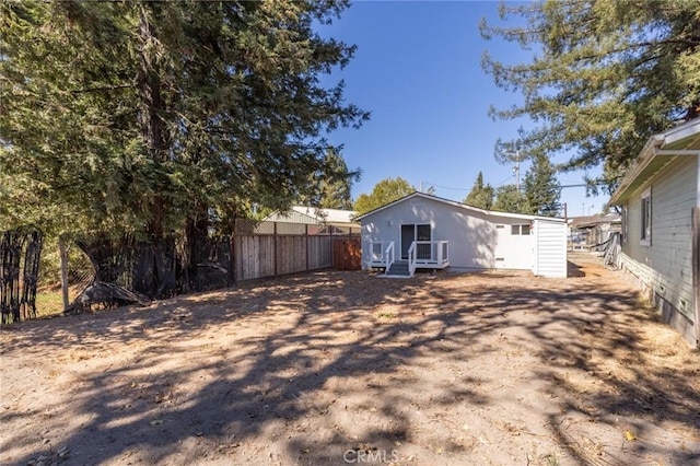 rear view of house featuring fence