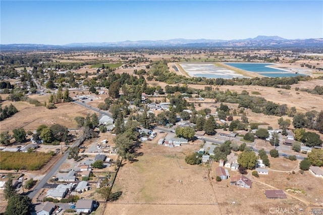 birds eye view of property with a water and mountain view