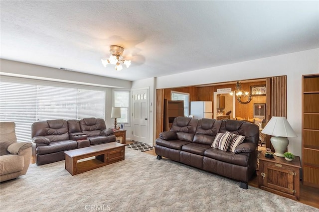 living area with a notable chandelier and a textured ceiling