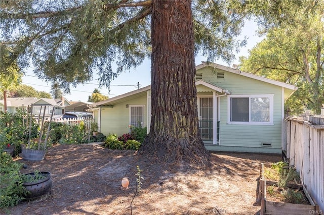 rear view of property with fence