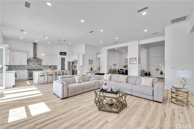 living room with sink and light wood-type flooring