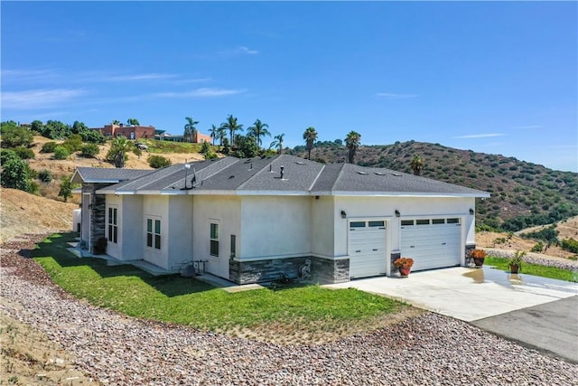 ranch-style house with a mountain view and a garage