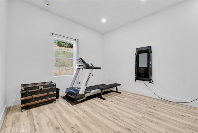 exercise room with light wood-type flooring