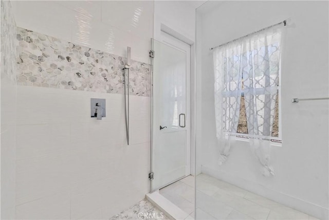 bathroom featuring a shower with shower door