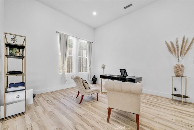 living area with light hardwood / wood-style flooring