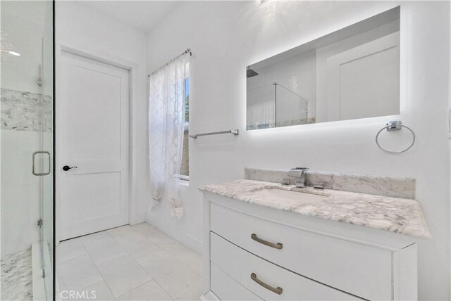 bathroom with vanity and a shower with shower door