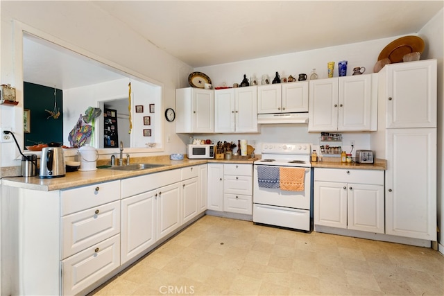 kitchen featuring white appliances, white cabinetry, and sink