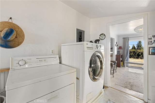 laundry room with washer and dryer and electric panel