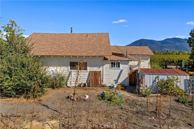 back of house with a mountain view