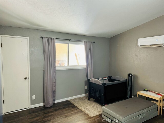 misc room featuring dark hardwood / wood-style floors, a wall mounted air conditioner, and vaulted ceiling