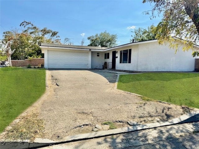 ranch-style house with a garage and a front lawn