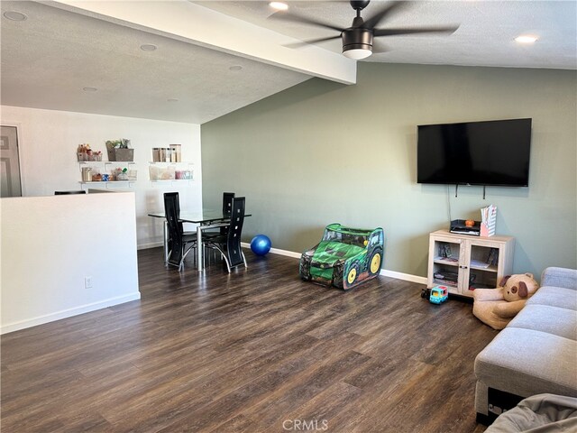 living room with lofted ceiling with beams, ceiling fan, dark hardwood / wood-style floors, and a textured ceiling