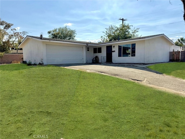 ranch-style house featuring a garage and a front yard