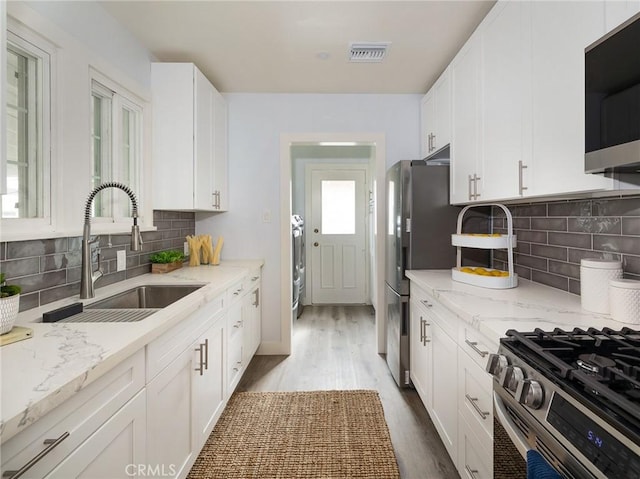5451 W 117th St, Hawthorne, CA 90304 - kitchen featuring stainless steel appliances, a sink, white cabinets, and wood finished floors