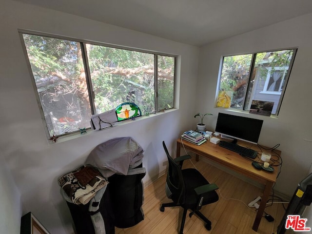 home office with hardwood / wood-style flooring