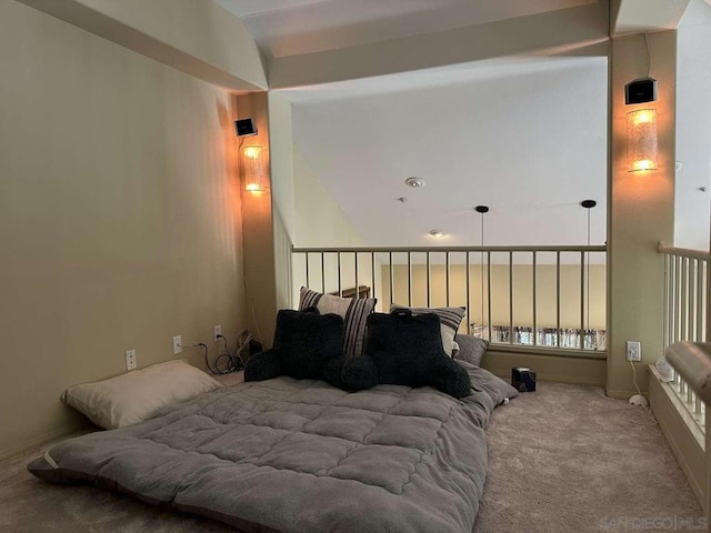 carpeted bedroom with lofted ceiling