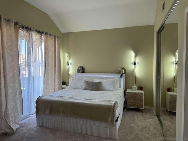 bedroom featuring carpet floors, a closet, and vaulted ceiling