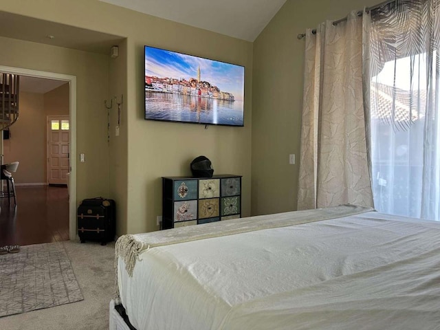 carpeted bedroom featuring lofted ceiling