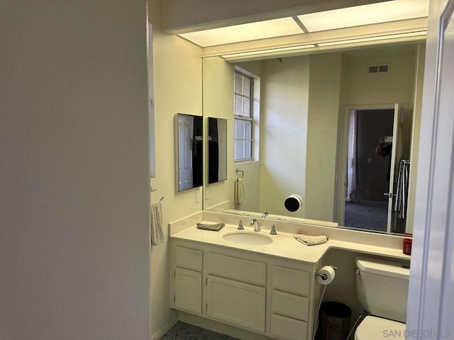 bathroom with vanity and toilet