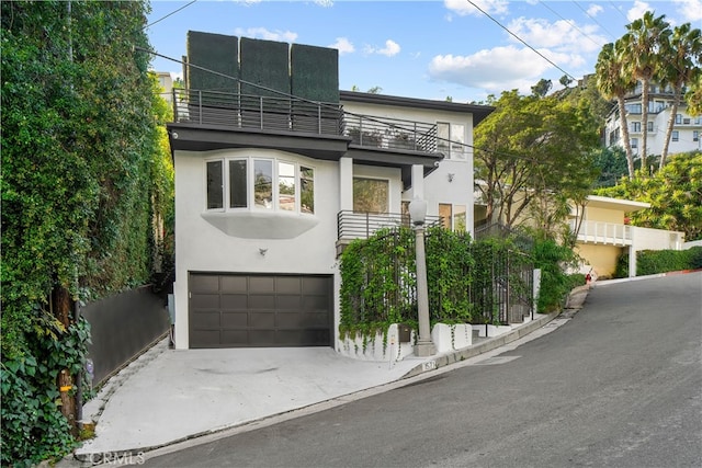 view of front of house featuring a balcony and a garage