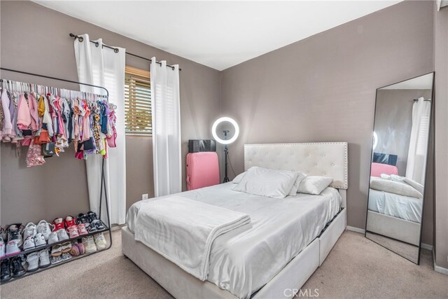 bedroom featuring light carpet