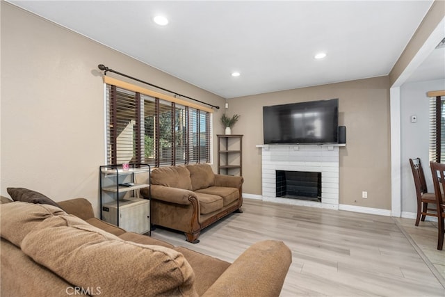 living room featuring light hardwood / wood-style flooring and a fireplace