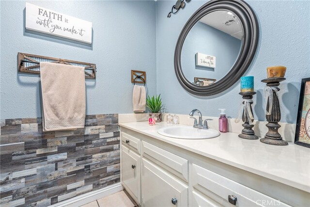 bathroom featuring tile patterned floors, vanity, and tile walls