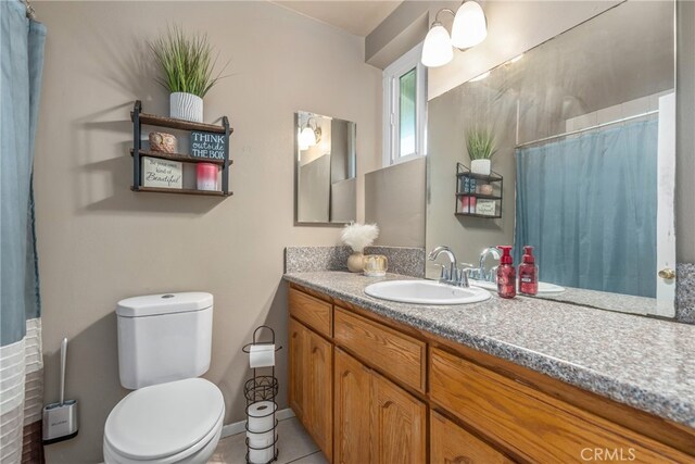 bathroom featuring vanity, toilet, and tile patterned floors