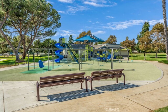 view of property's community featuring a playground and a yard