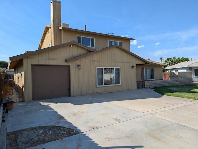 rear view of house featuring a garage