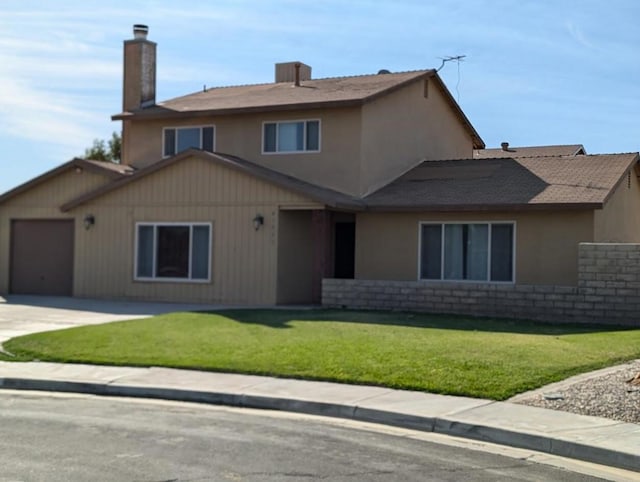 front of property featuring a garage and a front yard