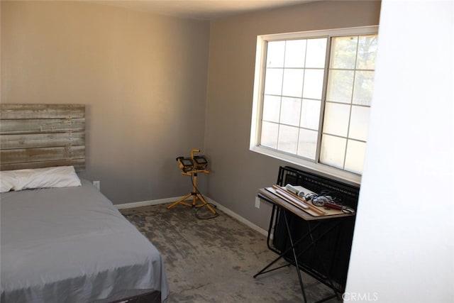 bedroom with carpet floors and multiple windows