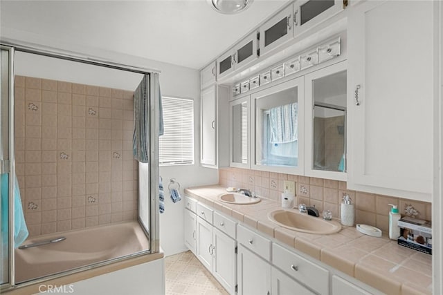 bathroom featuring backsplash, separate shower and tub, and vanity