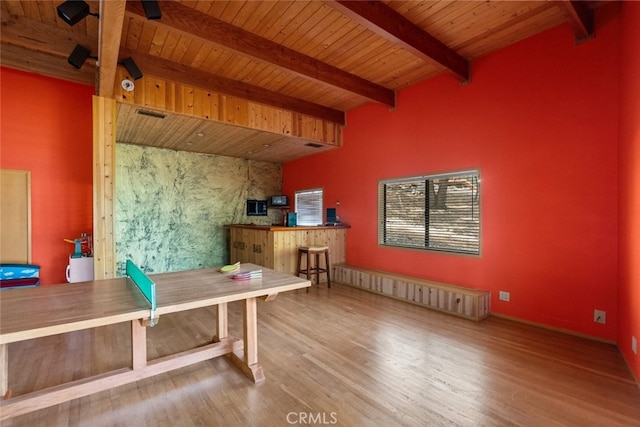 office space featuring beamed ceiling, hardwood / wood-style floors, and wooden ceiling