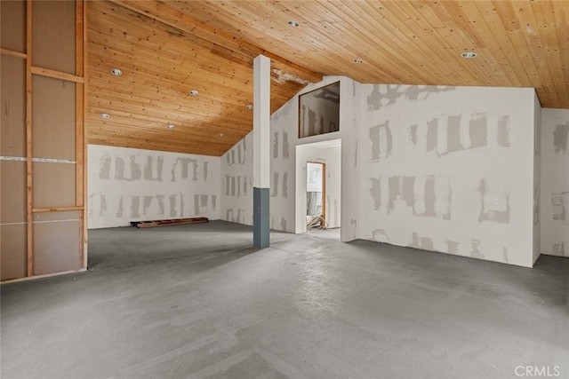 interior space with concrete flooring, wood ceiling, and high vaulted ceiling