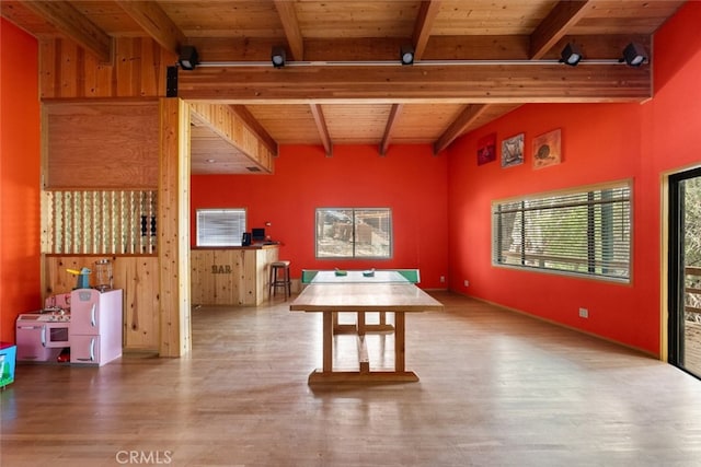 unfurnished dining area featuring wooden ceiling, hardwood / wood-style floors, and lofted ceiling with beams