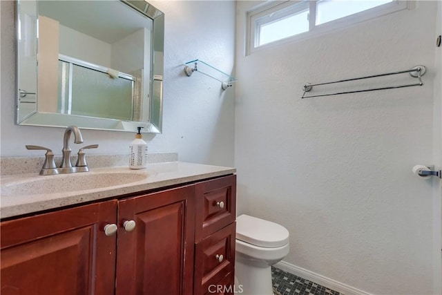 bathroom with tile patterned flooring, vanity, toilet, and a shower with door