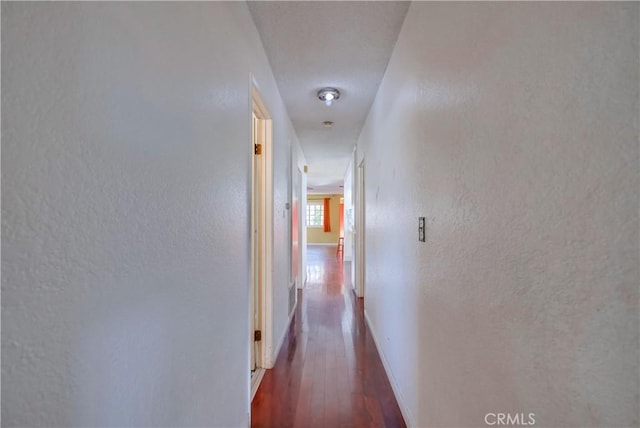 corridor featuring dark hardwood / wood-style flooring