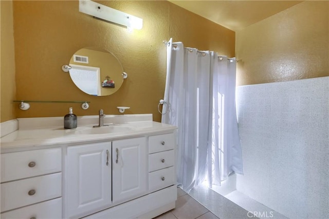 bathroom featuring tile patterned flooring and vanity